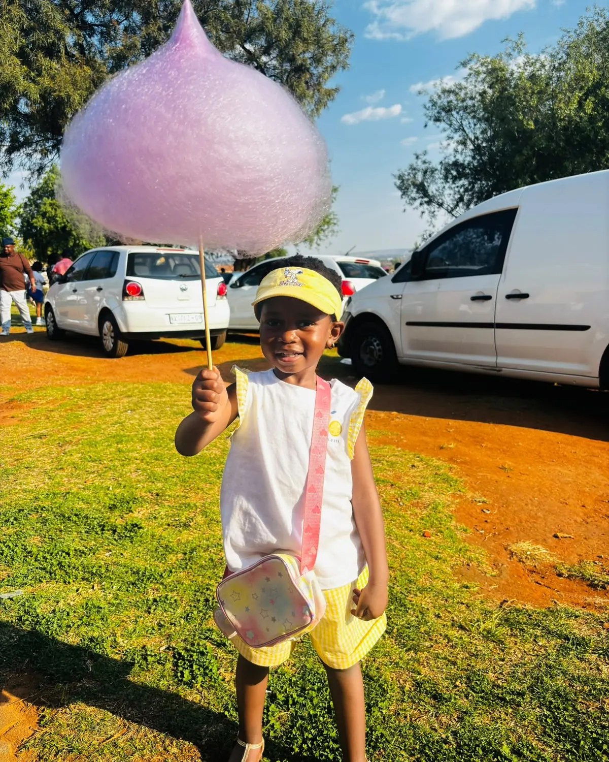 A girl holding an enormous pink candy floss at a Sedi Events booking