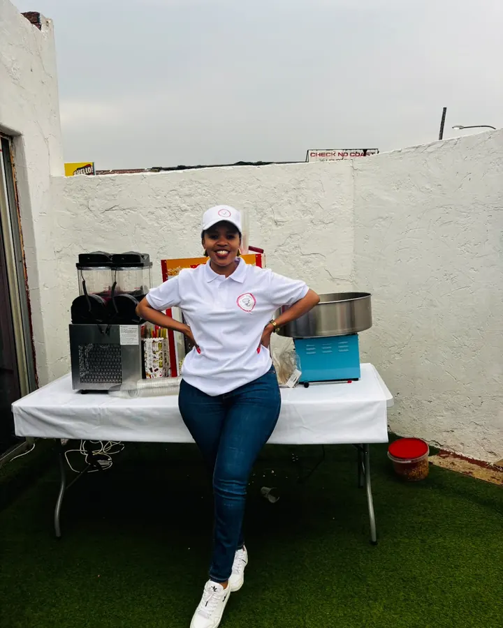 Gloria in Sedi Events uniform standing in front of the slush, popcorn and candy floss machines