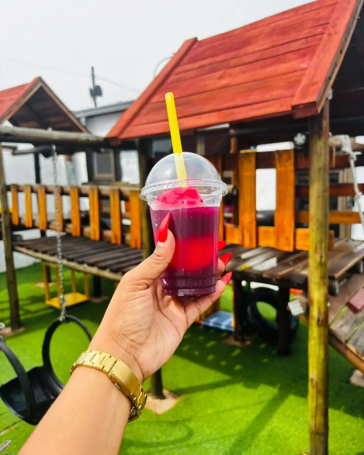A bright red and purple slush in a domed cup